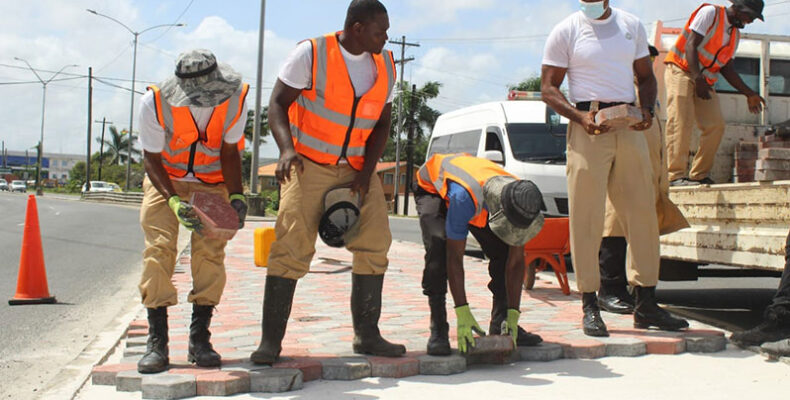 Police ranks assists in paving median at Rahaman’s Turn