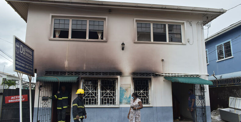 Fire destroys bottom flat of building housing D&J Shipping